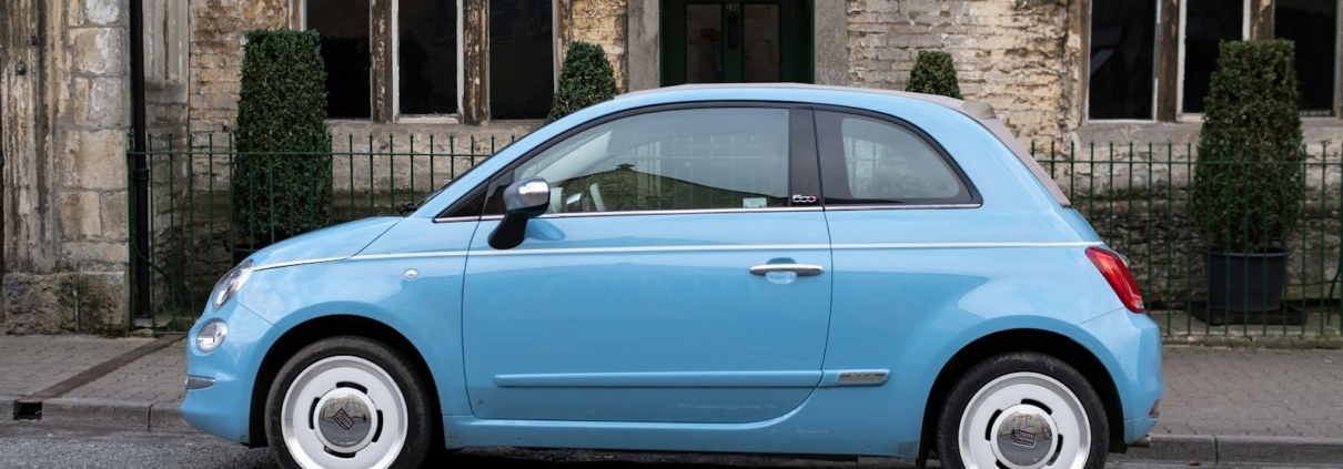 teal 3-door hatchback on road